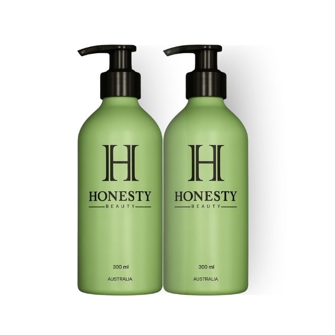 Two green bottles with black pump tops labeled 'Honesty Beauty' on a white background.