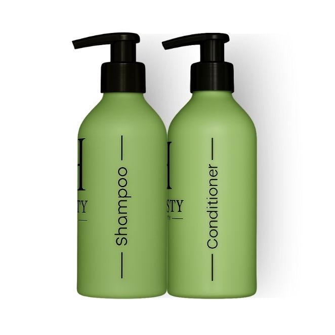 Two green bottles with black pump tops labeled 'Honesty Beauty' on a white background.